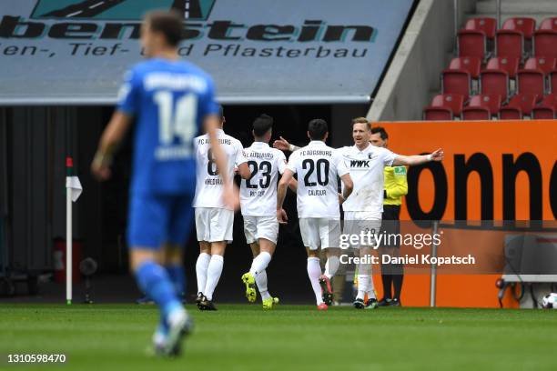 Andre Hahn of FC Augsburg celebrates with team mates Rani Khedira, Marco Richter and Daniel Caligiuri after scoring their side's second goal during...