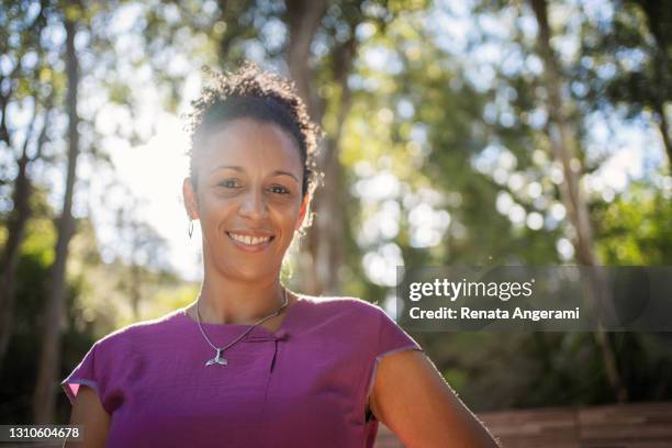 portrait of beautiful black woman outdoor with sunlight - 35 year old woman stock pictures, royalty-free photos & images