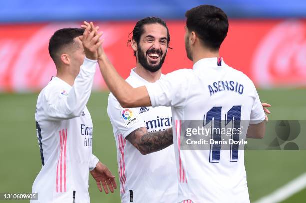 Marco Asensio of Real Madrid celebrates with team mates Lucas Vazquez and Isco after scoring their side's first goal but it is later disallowed...