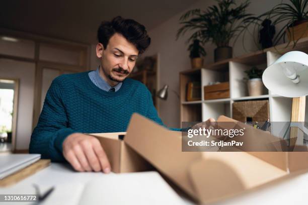 frustrated young male customer with wrong delivery package - wrong package stock pictures, royalty-free photos & images