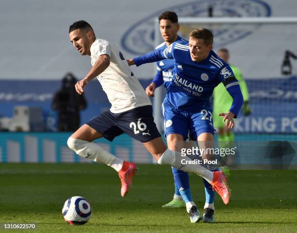 Riyad Mahrez of Manchester City is challenged by Timothy Castagne of Leicester City during the Premier League match between Leicester City and...