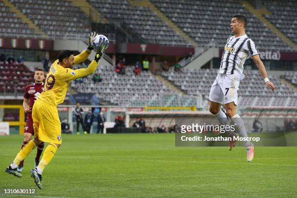 Cristiano Ronaldo of Juventus leaps in front of Salvatore Sirigu of Torino FC in an attempt to distract him as he gathers a cross during the Serie A...