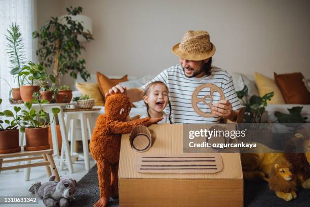 daughter and father are on safari at home with a handmade cartoncar - cardboard car stock pictures, royalty-free photos & images