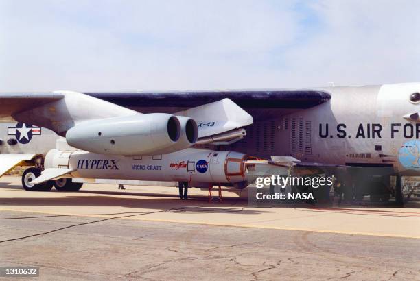 The X-43A hypersonic research aircraft, left, and its modified Pegasus booster rocket are nestled under the wing of NASA''s NB-52B carrier aircraft...