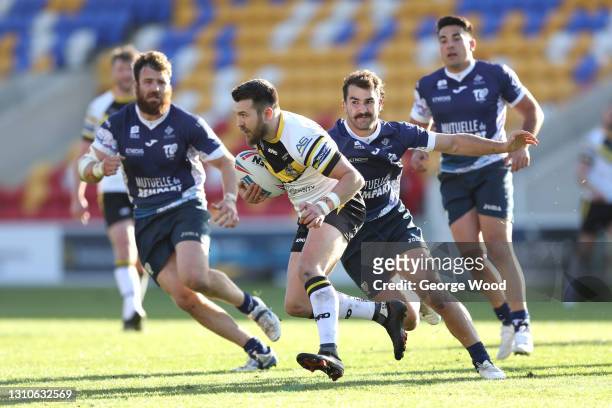 Matty Marsh of York City Knights breaks away from Mathieu Jussaume of Toulouse Olympique XIII during the Betfred Championship match between York City...