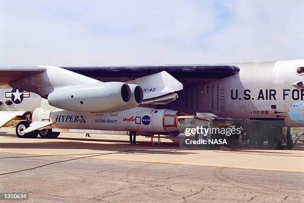 An X-43A hypersonic experimental aircraft, left, and its modified Pegasus booster rocket are fastened under the wing of a NASA B-52B aircraft March...