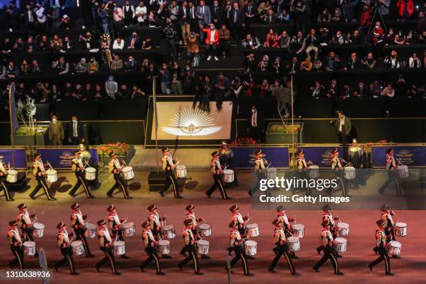 Artists perform as part of a convey transporting mummies from the Egyptian Museum in Tahrir Square to the new National Museum of Egyptian...