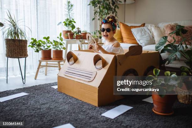 little cute girl is going to the party  with a handmade cartoncar - cardboard car stock pictures, royalty-free photos & images