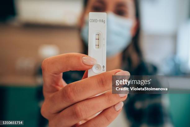 positive test result by using rapid test device for covid-19. - coronavirus stock pictures, royalty-free photos & images