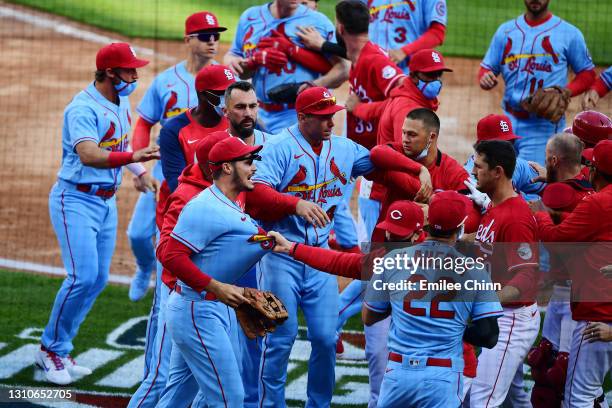 The Cincinnati Reds and St. Louis Cardinals fight in the fourth inning over a run by Nick Castellanos of the Cincinnati Reds at Great American Ball...