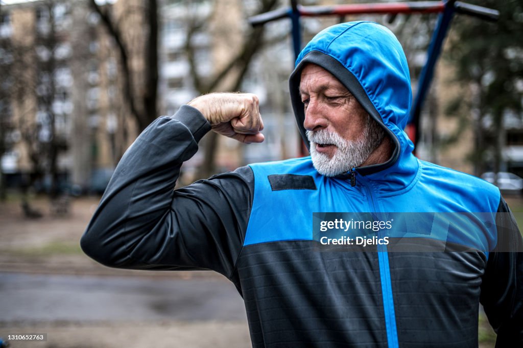 Senior male bodybuilder flexing his biceps.