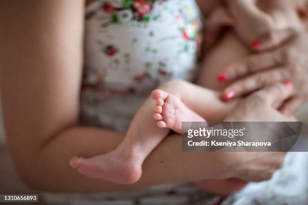 mom gently holds a baby in her arms -stock photo - maternity leave stockfoto's en -beelden