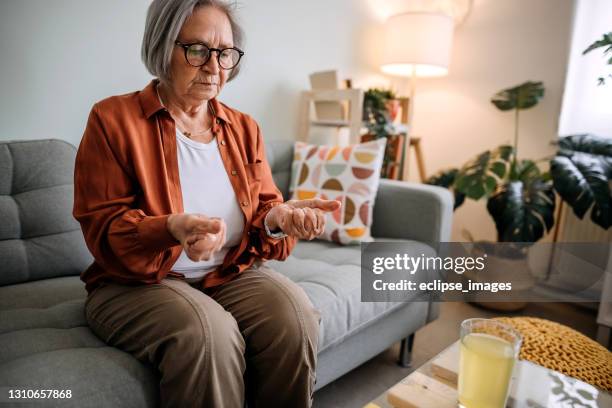 senior woman - rheumatoid arthritis hand stock pictures, royalty-free photos & images