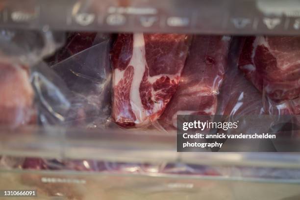 frozen vacuum-sealed pork cutlets - frozen meat stock pictures, royalty-free photos & images