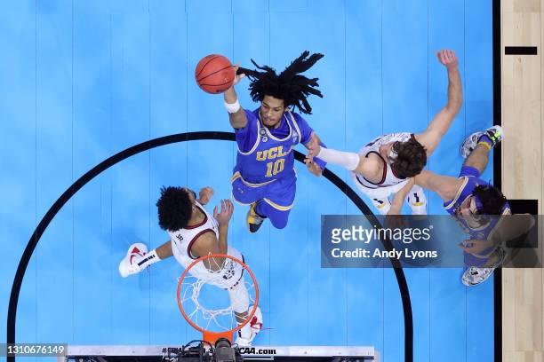 Tyger Campbell of the UCLA Bruins shoots the ball in the first half as he is defended by Corey Kispert of the Gonzaga Bulldogs during the 2021 NCAA...