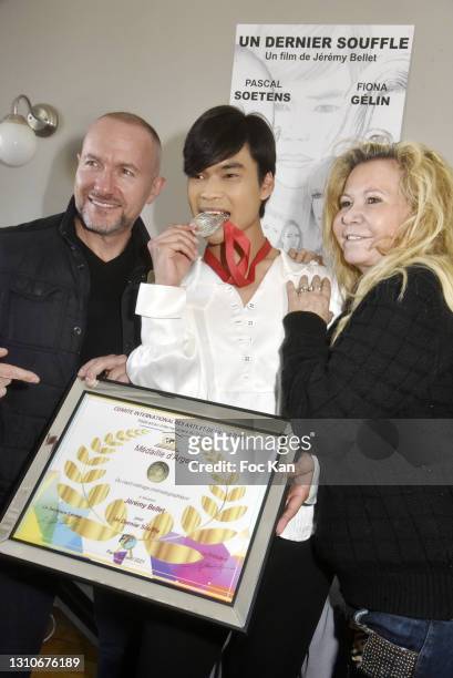 Director Jeremy Bellet receives an International Art and Culture silver medal from Fédération Internationale du Tourisme and poses with Fiona Gélin...