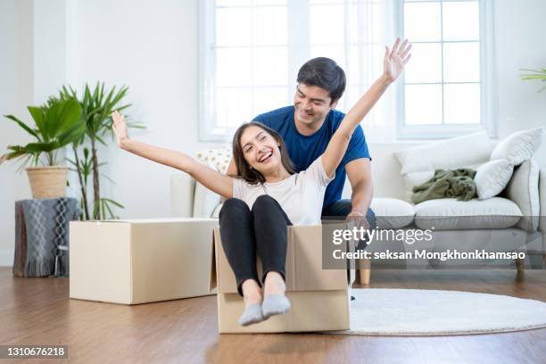 happy  young couple riding in box on moving day - kevin dickson and jack ketsoyan celebrate the release of their new book guilty pleasure stockfoto's en -beelden