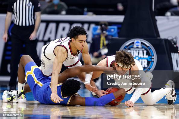 Cody Riley Cody Riley of the UCLA Bruins competes for a loose ball with Andrew ...