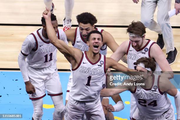 Jalen Suggs of the Gonzaga Bulldogs celebrates with teammates after making a game-winning three point basket in overtime to defeat the UCLA Bruins...