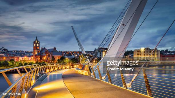 northern ireland derry the peace bridge river foyle night panorama londonderry - ireland stock pictures, royalty-free photos & images