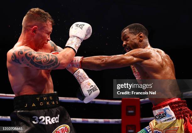 Jamel Herring of the USA and Carl Frampton of Northern Ireland exchange punches during the WBO World Super Featherweight Title Fight between Jamel...