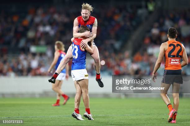 Clayton Oliver of the Demons congratulates James Jordon of the Demons after kicking a goal during the round 3 AFL match between the GWS Giants and...