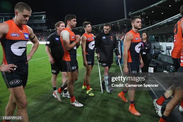 Toby Greene of the Giants talks to injured captain Stephen Coniglio of the Giants after losing the round 3 AFL match between the GWS Giants and the...