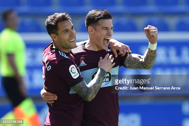 Santi Mina of Celta Vigo celebrates with teammate Hugo Mallo after scoring their team's third goal during the La Liga Santander match between...