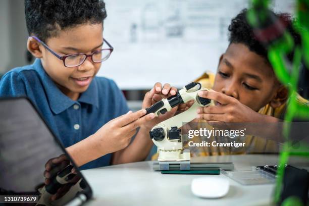 teamwork of children during assembly and simulate robot with coding it for present in classroom. - primary school science stock pictures, royalty-free photos & images