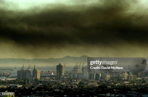 Toxic smoke blows over downtown Long Beach, CA, April 23, 2001 from a fire at the Tosco oil refinery in Carson, 15 miles south of Los Angeles. The...