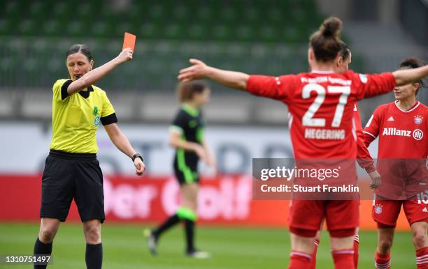 Match Referee Susann Kunkel shows a red card to Simone Boye Soerensen of FC Bayern Munchen during the Women's DFB Cup Semi-Final match between VfL...