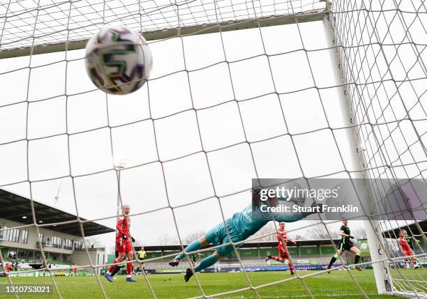 Laura Benkarth of FC Bayern Munchen dives but fails to save the ball for VfL Wolfsburg's first goal scored by Alexandra Popp of Vfl Wolfsburg during...