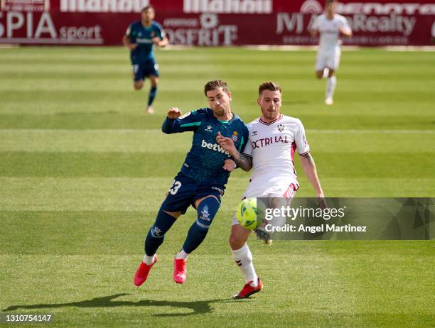 Adrian Embarba of RCD Espanyol competes for the ball with Diego Caballo of Albacete BP during the Liga Smartbank match between Albacete BP and RCD...