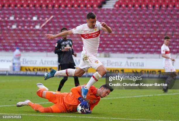 Jiri Pavlenka of SV Werder Bremen makes a save from the feet of Philipp Foerster of VfB Stuttgart during the Bundesliga match between VfB Stuttgart...