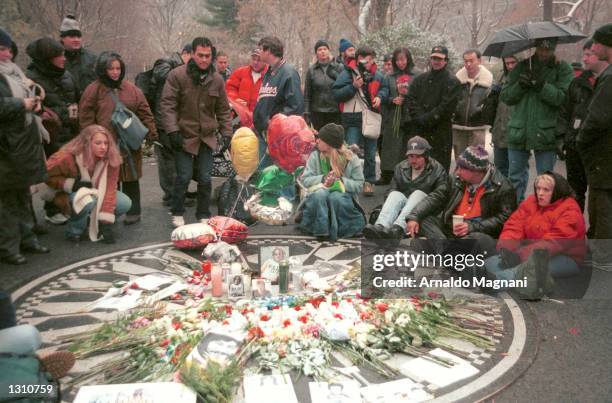 Fans of John Lennon gather in Strawberry Fields in Central Park to remember him on the anniversary of his murder December 8, 2000 in New York City.