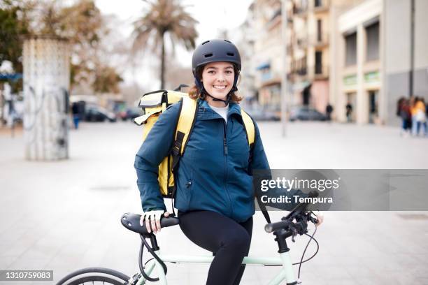 one home delivery female looking at camera. - bicycle messenger stock pictures, royalty-free photos & images