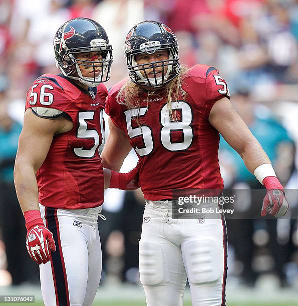 Brian Cushing of the Houston Texans talks with Brooks Reed in between plays against the Jacksonville Jaguars at Reliant Stadium on October 30, 2011...