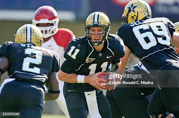 Quarterback Jordan Rodgers of the Vanderbilt Commodores hands off during a college football game against the Arkansas Razorbacks at Vanderbilt...