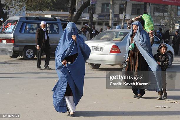 Women in burkas walk on the street on October 15, 2011 in Kabul, Afghanistan.