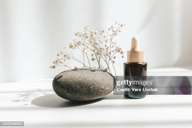 brown glass with a dropper. bottle mockup cosmetic oil dropper on a grey background and shadows. copy space - beauty cosmetic luxury studio background stock pictures, royalty-free photos & images