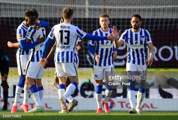 Matheus Cunha, Lukas Kluenter and Maximilian Mittelstaedt celebrate after their team mate Dodi Lukebakio of Hertha BSC scored their side's first goal...