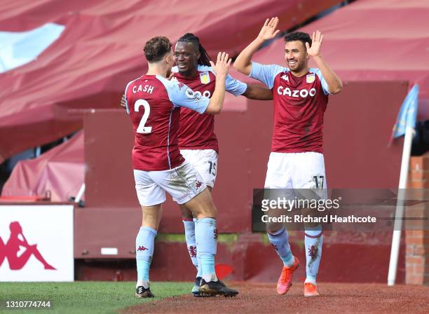 Trezeguet of Aston Villa celebrates with team mates Matty Cash and Bertrand Traore after scoring their side's second goal during the Premier League...