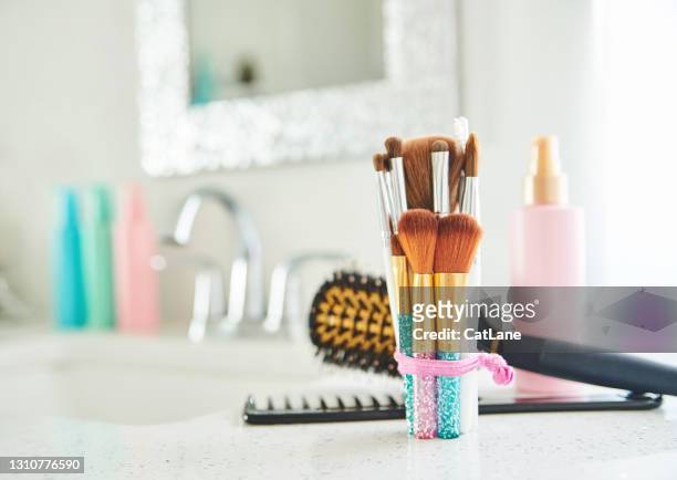 collection of make-up brushes and personal care products in bright modern bathroom - bathroom arrangement stock pictures, royalty-free photos & images
