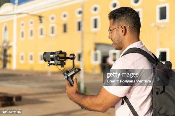 cameraman capturing images outdoors - record producers stock pictures, royalty-free photos & images