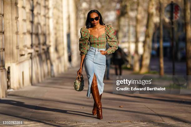 Emilie Joseph @in_fashionwetrust wears a green checked top with big puff shoulder sleeves and low neck from Rejina Pyo, a midi length skirt in denim...