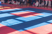 Sports background. Red-blue colors of traditional soft floor covering for karate, taekwono practice.