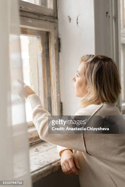 woman pointing with finger - winter sadness stock pictures, royalty-free photos & images