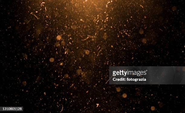 golden flying particles abstract background - glamour stock-fotos und bilder