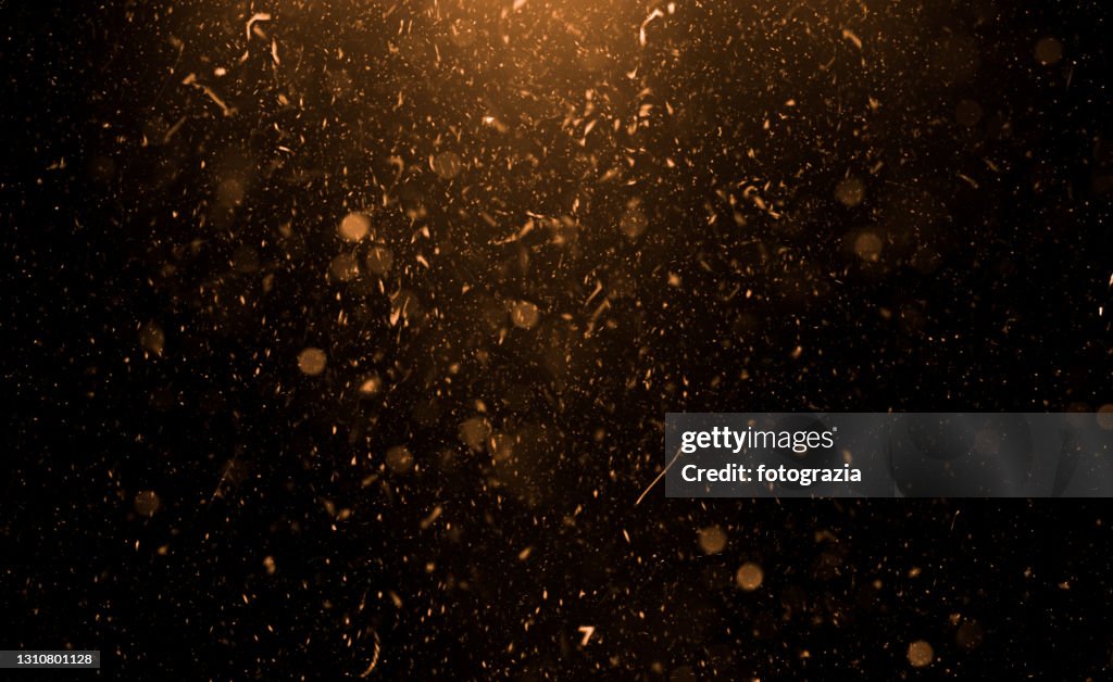 Golden Flying Particles Abstract Background
