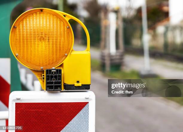 warning light at a construction site on the street - road works stock pictures, royalty-free photos & images